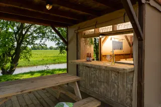 The Village: outdoor bar and picnic table under the roof