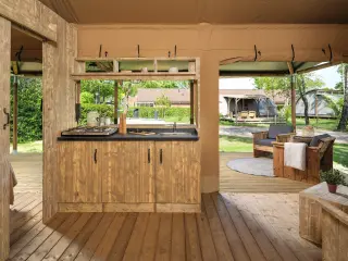 Luxury Suite: kitchenette with a sink and a view of the terrace
