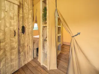 Wood Lodge Midi: canvas curtain tied back beside a wooden door