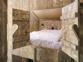 Luxury Safari Lodge: bedroom with a double bed seen between wooden doors