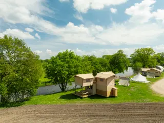 The Village: the tent seen from the path by the river