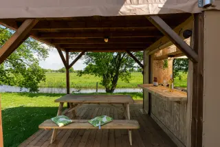 The Village: covered area with a picnic table and a bar