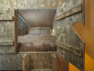 Wood Lodge: bed seen between wooden doors