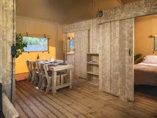 Luxury Suite: dining area with a sliding wooden door