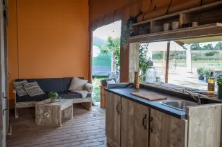 Glamping Lodge 35: kitchen with a sink and a pass-through window to the terrace