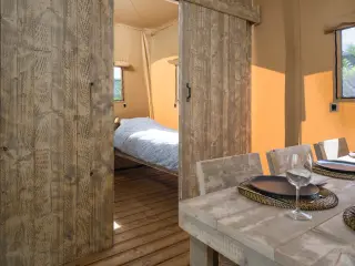 Luxury Suite: dining area with the bedroom in the background