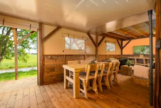 The Village: dining area with windows onto the meadow