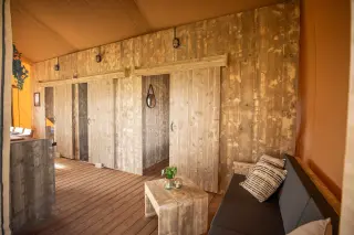 Glamping Lodge 35: living area with a sofa and sliding wooden doors