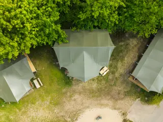 Luxury Safari Lodge: overhead view of three tents among the trees