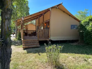 Glamping Lodge 35: the tent on a raised platform with stairs, among trees
