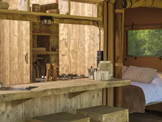 Luxury Suite: kitchenette with a cooktop next to the bedroom